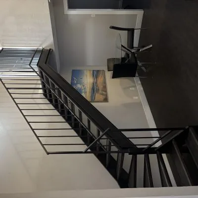 Affordable two-bedroom men’s sober living apartment in Austin with staircase and dining area under natural lighting