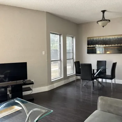 Affordable shared living area in Austin men’s sober apartment with sofa and TV