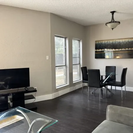 Affordable shared living area in Austin men’s sober apartment with sofa and TV