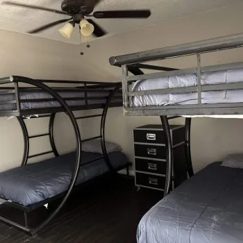 Affordable men’s sober living bedroom in Austin with twin bunks and modern dark flooring