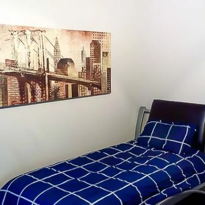 Private bedroom with modern decor in men’s sober living housing at Eudaimonia Recovery Homes in Austin.