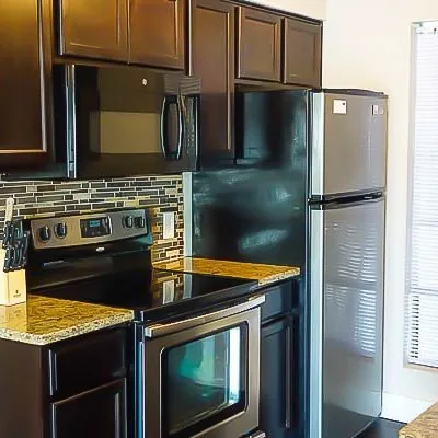 Updated kitchen with appliances in men’s sober living apartments at Eudaimonia Recovery Homes in Austin, TX.